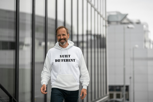 Man wearing a off white hoodie with text, standing in front of a modern building.