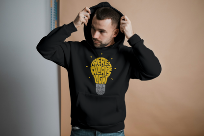 Man wearing a black hoodie with yellow text against a plain background